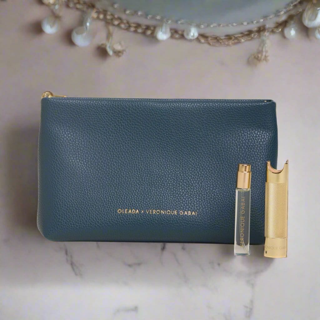 Veronique Gabai's collaboration with Oleada: a blue leather pouch, a 10ml travel perfume spray, and its matching travel case in gold. 