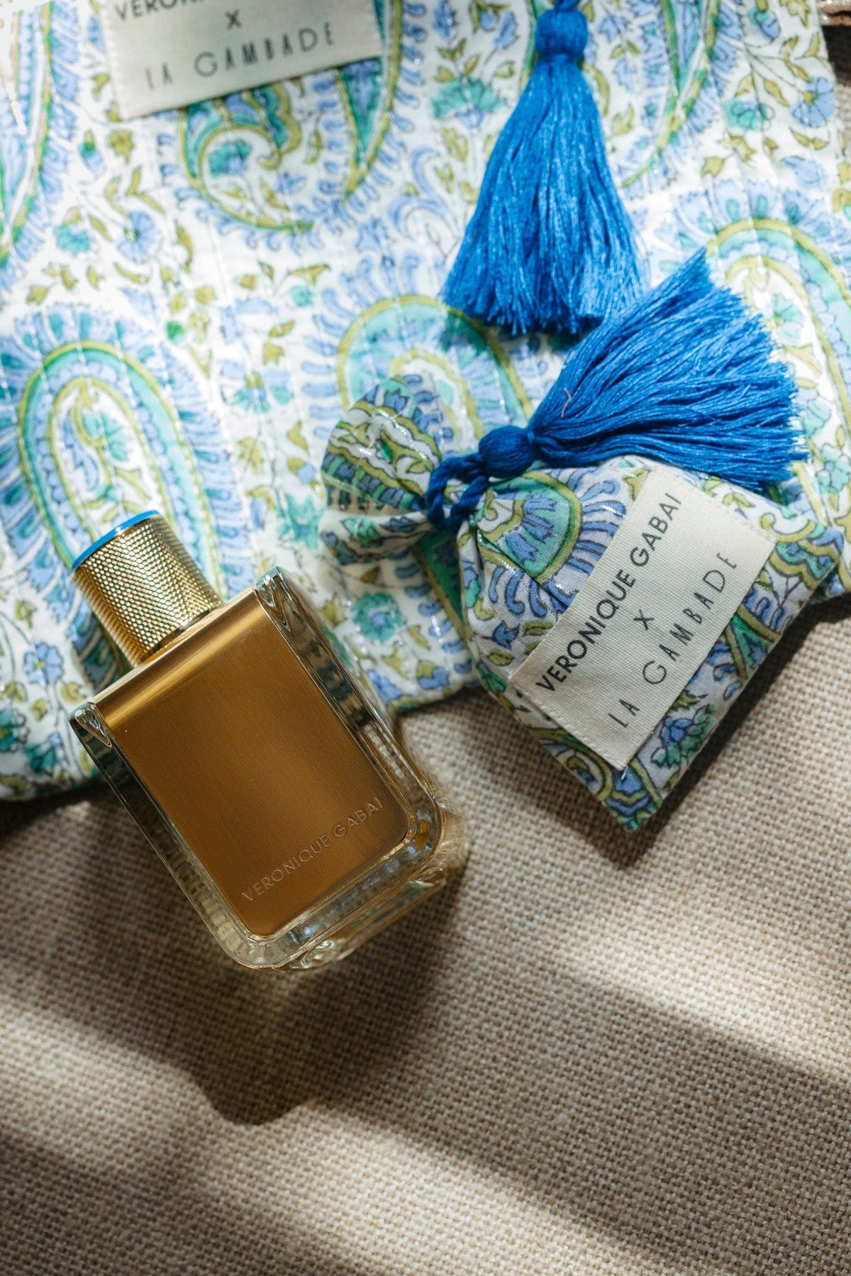 Veronique Gabai's collaboration with La Gambade: an 85ml gold perfume bottle with a blue and green quited pouche. 